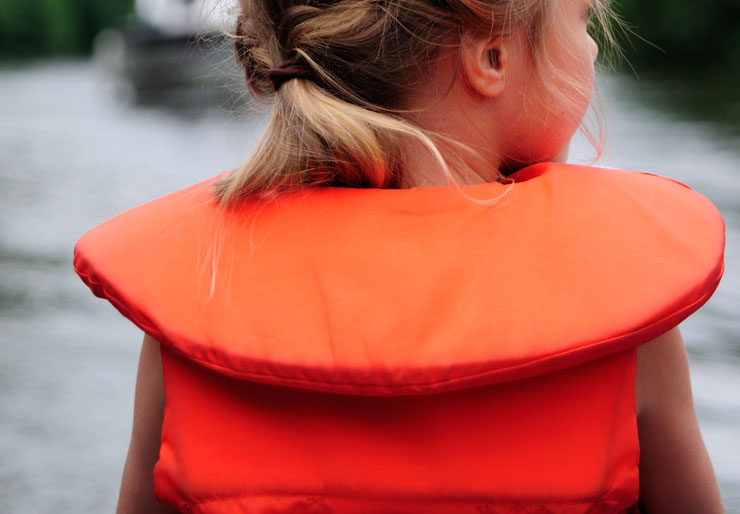 Young girl with orange life jacket