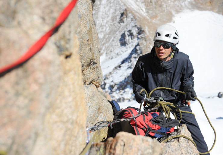 Male climber with helmet and climbing gear