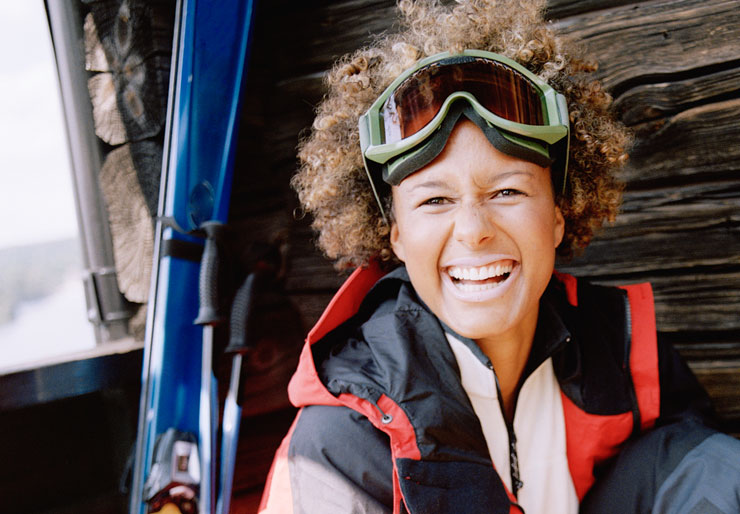Female smiling and wearing ski goggles