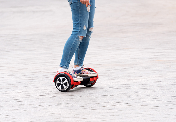 Legs standing on hoverboard