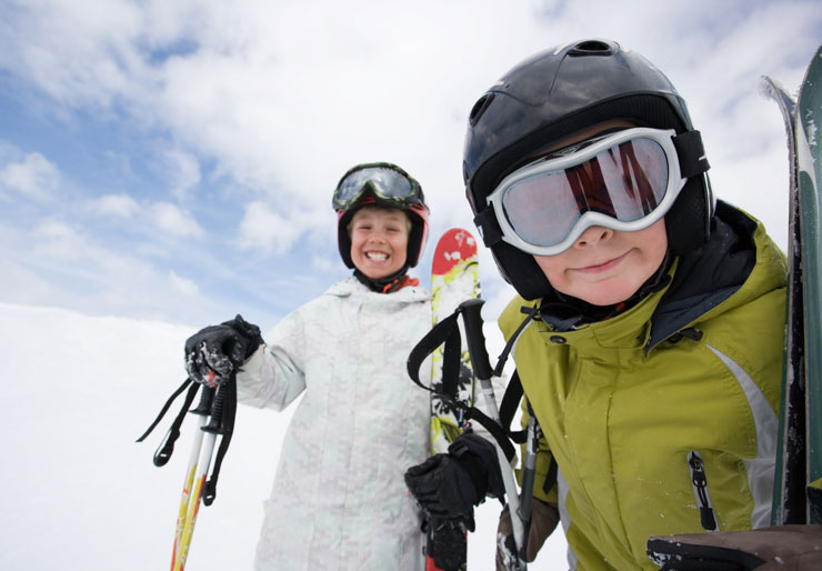 Two kids wearing ski goggles